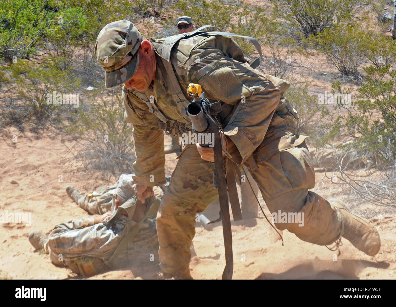 DONA ANNA RANGE, NEW MEXICO– Air Force Master Sgt. Ernest Willich pulls a  “dead Ranger” up a sandy hill as part of a corrective training exercise  during Pre-Ranger training April 21. The