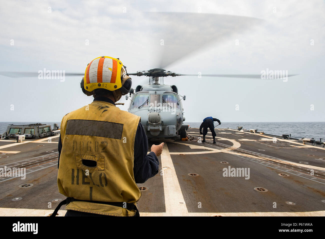 160406-N-MD297-033 PACIFIC OCEAN (April 6, 2016) - Sailors assigned to the Arleigh Burke-class guided missile destroyer USS Lassen (DDG 82) secure an MH-60R helicopter from the 'Jaguars' of Helicopter Maritime Strike Squadron (HSM) 60 to the ship's flight deck during flight operations. Lassen is currently underway in support of Operation Martillo, a joint operation with the U.S. Coast Guard and partner nations within the 4th Fleet area of responsibility. Operation Martillo is being led by Joint Interagency Task Force South, in support of U.S. Southern Command. (U.S. Navy photo by Mass Communic Stock Photo