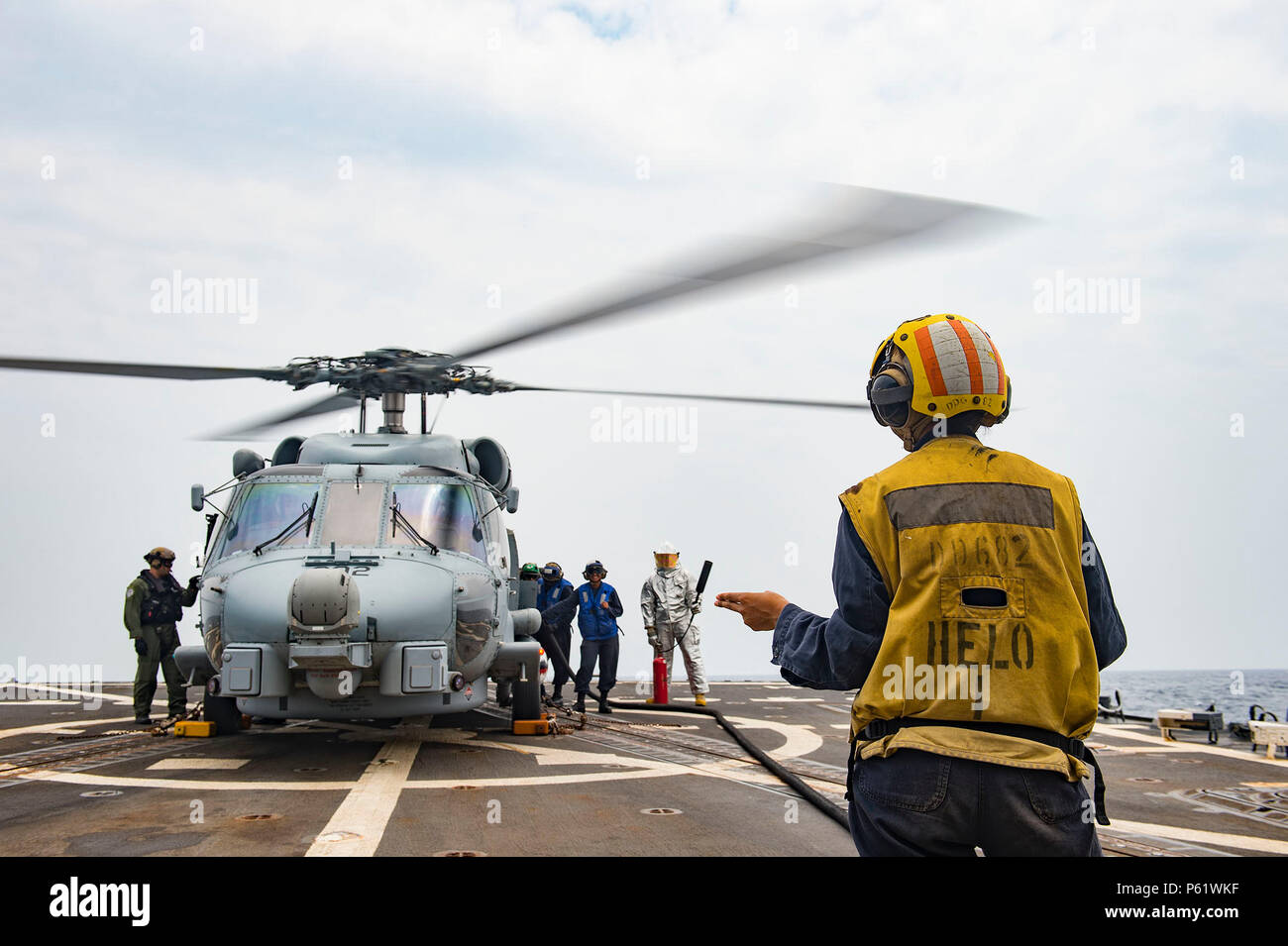 160406-N-MD297-047 PACIFIC OCEAN (April 6, 2016) - Sailors assigned to the Arleigh Burke-class guided-missile destroyer USS Lassen (DDG 82) fuel an MH-60R helicopter from the 'Jaguars' of Helicopter Maritime Strike Squadron (HSM) 60. Lassen is currently underway in support of Operation Martillo, a joint operation with the U.S. Coast Guard and partner nations within the 4th Fleet area of responsibility. Operation Martillo is being led by Joint Interagency Task Force South, in support of U.S. Southern Command. (U.S. Navy photo by Mass Communication Specialist 2nd Class Huey D. Younger Jr./Releas Stock Photo
