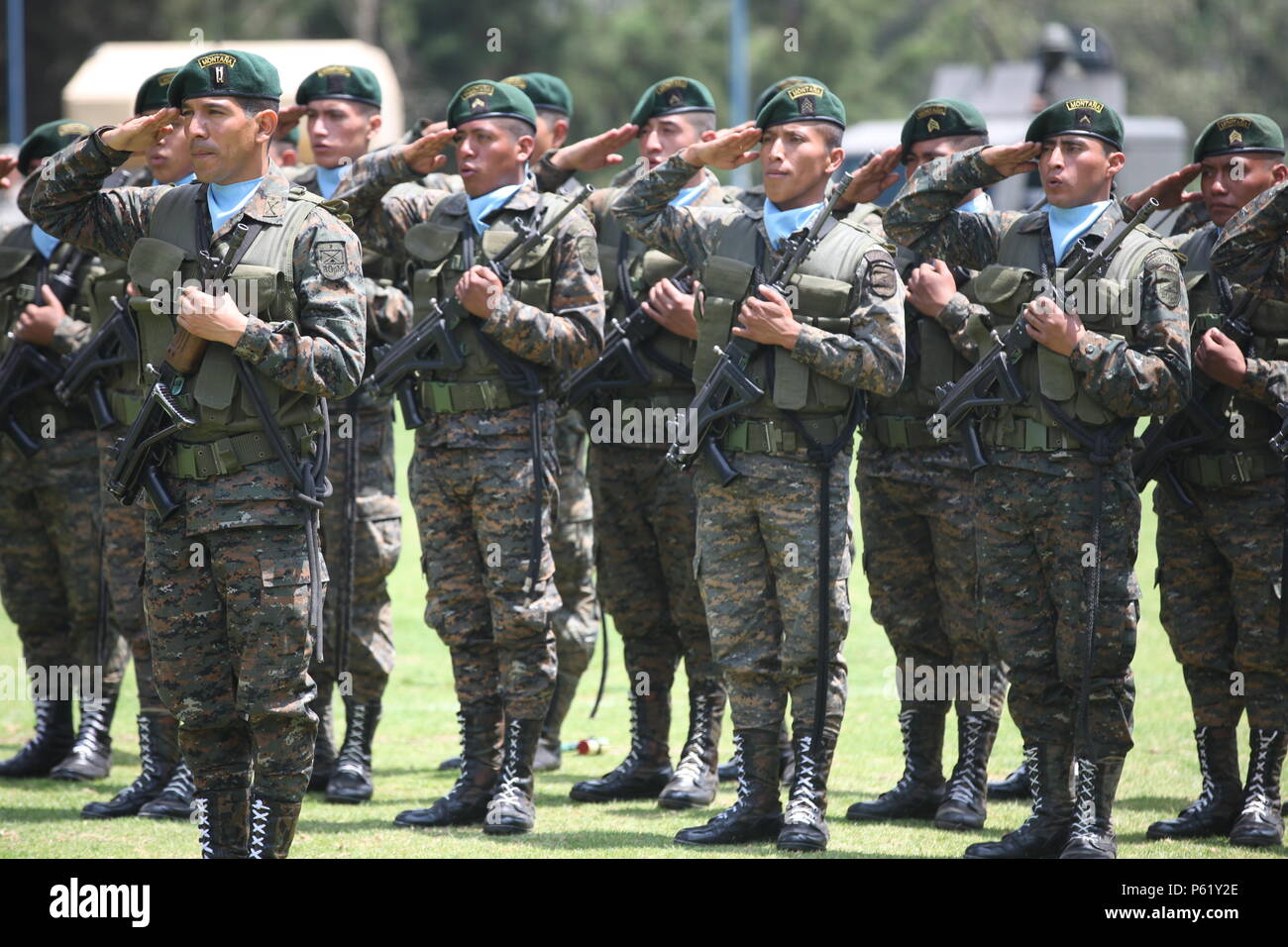 Guatemalan soldiers render a salute during the playing of the Guatemalan national anthem during the opening ceremony for Operation Beyond The Horizon at the Guatemalan army mountain division base at San Marcos, Guatemala, April 7th, 2016. Task Force Red Wolf and Army South conducts Humanitarian Civil Assistance Training to include tactical level construction projects and Medical Readiness Training Exercises providing medical access and building schools in Guatemala with the Guatemalan Government and non-government agencies from 05MAR16 to 18JUN16 in order to improve the mission readiness of US Stock Photo
