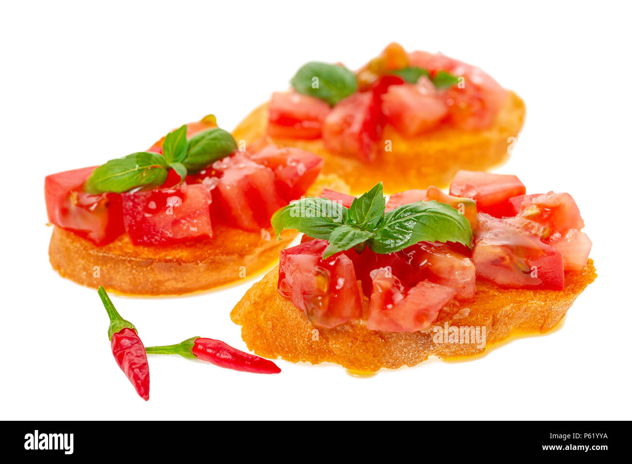savory tasty chopped tomato on toasted baguette garnished with basil and peppers, Italian