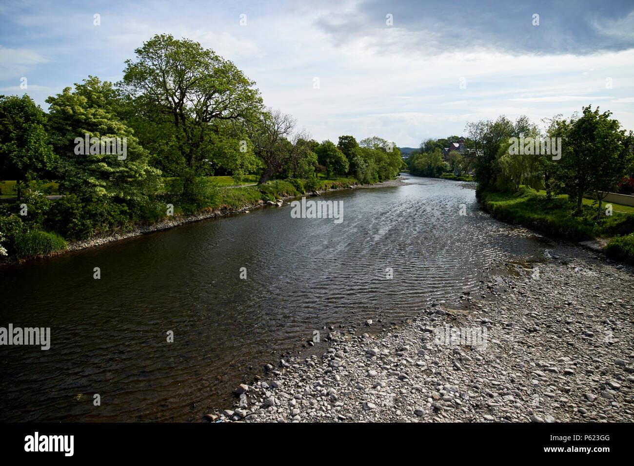 The river Derwent flowing through Cockermouth with low water level Cumbria England UK Stock Photo