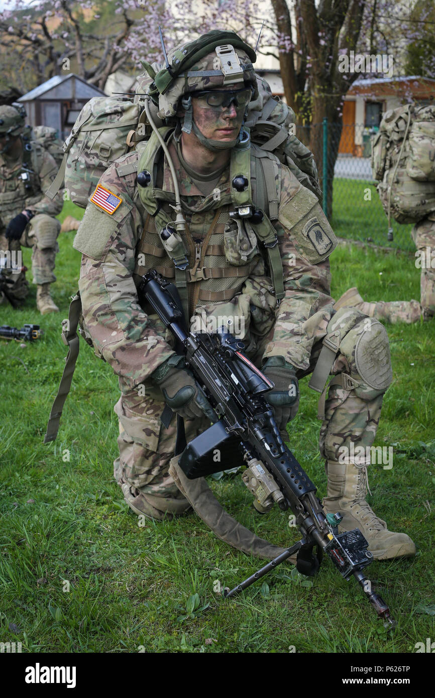 A U.S. Soldier of 1st Battalion, 503rd Infantry Regiment, 173rd Airborne Brigade provides security while conducting a movement to contact scenario during exercise Saber Junction 16 at the U.S. Army’s Joint Multinational Readiness Center (JMRC) in Hohenfels, Germany, April 12, 2016. Saber Junction 16 is the U.S. Army Europe’s 173rd Airborne Brigade’s combat training center certification exercise, taking place at the JMRC in Hohenfels, Germany, Mar. 31-Apr. 24, 2016.  The exercise is designed to evaluate the readiness of the Army’s Europe-based combat brigades to conduct unified land operations  Stock Photo
