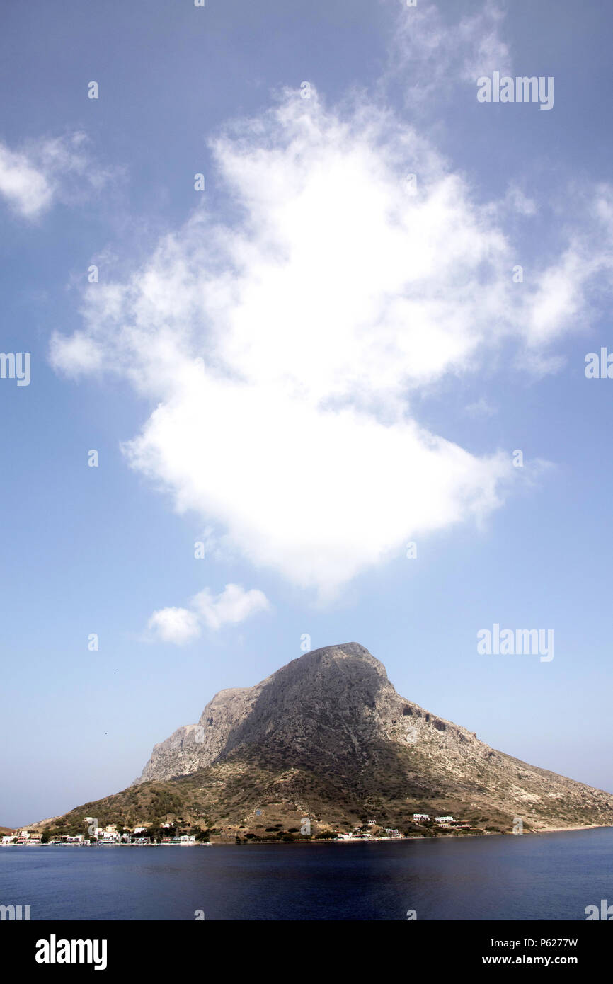 Telendos island, white cloud and shadow, seen from Kalymnos, Greece Stock Photo