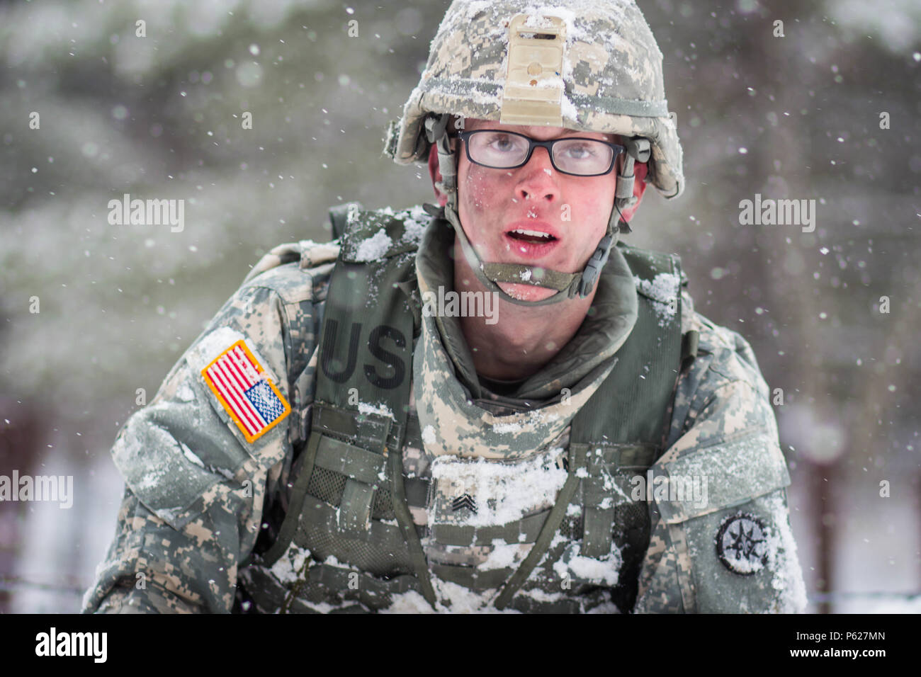 Sgt. John Dana, winner in the non-commissioned officer category, demonstrates an Army Warrior Task as snow falls on the first day of competition of the 377th Theater Sustainment Command Best Warrior Competition. Dana represented the 316th Sustainment Command (Expeditionary) in the competition. Dana, a native of Naugatuck, Conn., was among 11 Soldiers from across the 377th TSC vying for the command’s Best Warrior title and the opportunity to represent the command at the U.S. Army Reserve Command competition at Fort Bragg, N.C. May 1-7, 2016. Stock Photo