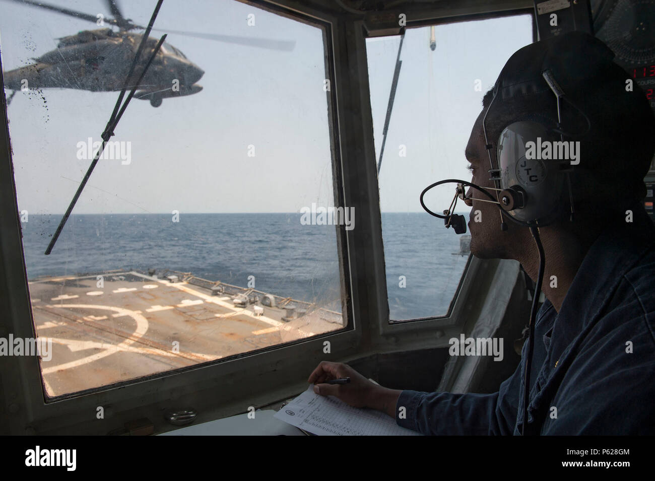 160414-N-MD297-161 PACIFIC OCEAN (April 14, 2016) Lt. j.g. Adam Johnson watches an Army UH-60 Blackhawk helicopter from the 1st Battalion, 228th Aviation Regiment take off from the flight aboard the Arleigh Burke-class guided-missile destroyer USS Lassen (DDG 82) while conducting deck landing qualifications (DLQs). Lassen is currently underway in support of Operation Martillo, a joint operation with the U.S. Coast Guard and partner nations within the 4th Fleet area of responsibility. Operation Martillo is being led by Joint Interagency Task Force South, in support of U.S. Southern Command. (U. Stock Photo
