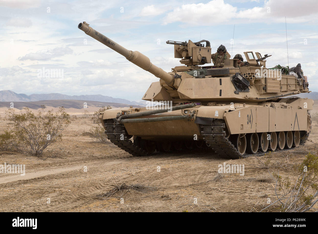 U.S. Army Soldiers assigned to the 1st Battalion, 67th Armored Regiment, 3rd Brigade Combat Team, 1st Armored Division, maneuver their M1A1 Abrams tank during Decisive Action Training Exercise 16-05 at the National Training Center in Fort Irwin, Calif., April 10, 2016. Decisive Action Training Exercises at the National Training Center ensure units remain versatile, responsive, and consistently available for current and future contingencies. (U.S. Army photo by Pfc. Daniel Parrott, Operations Group, National Training Center) Stock Photo