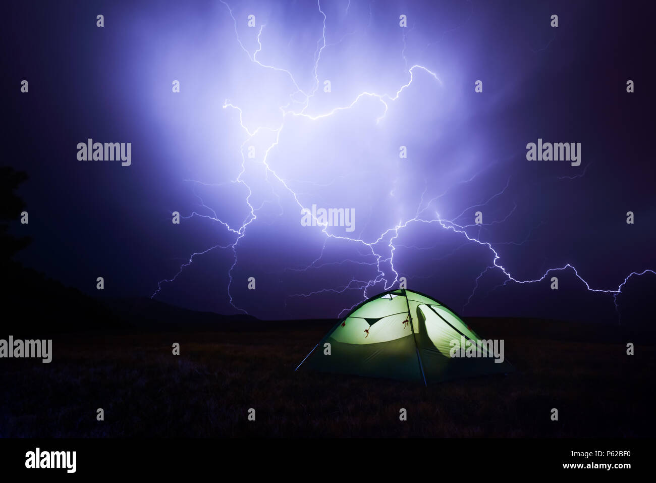 Incredible sky with lightning and tent Stock Photo Alamy