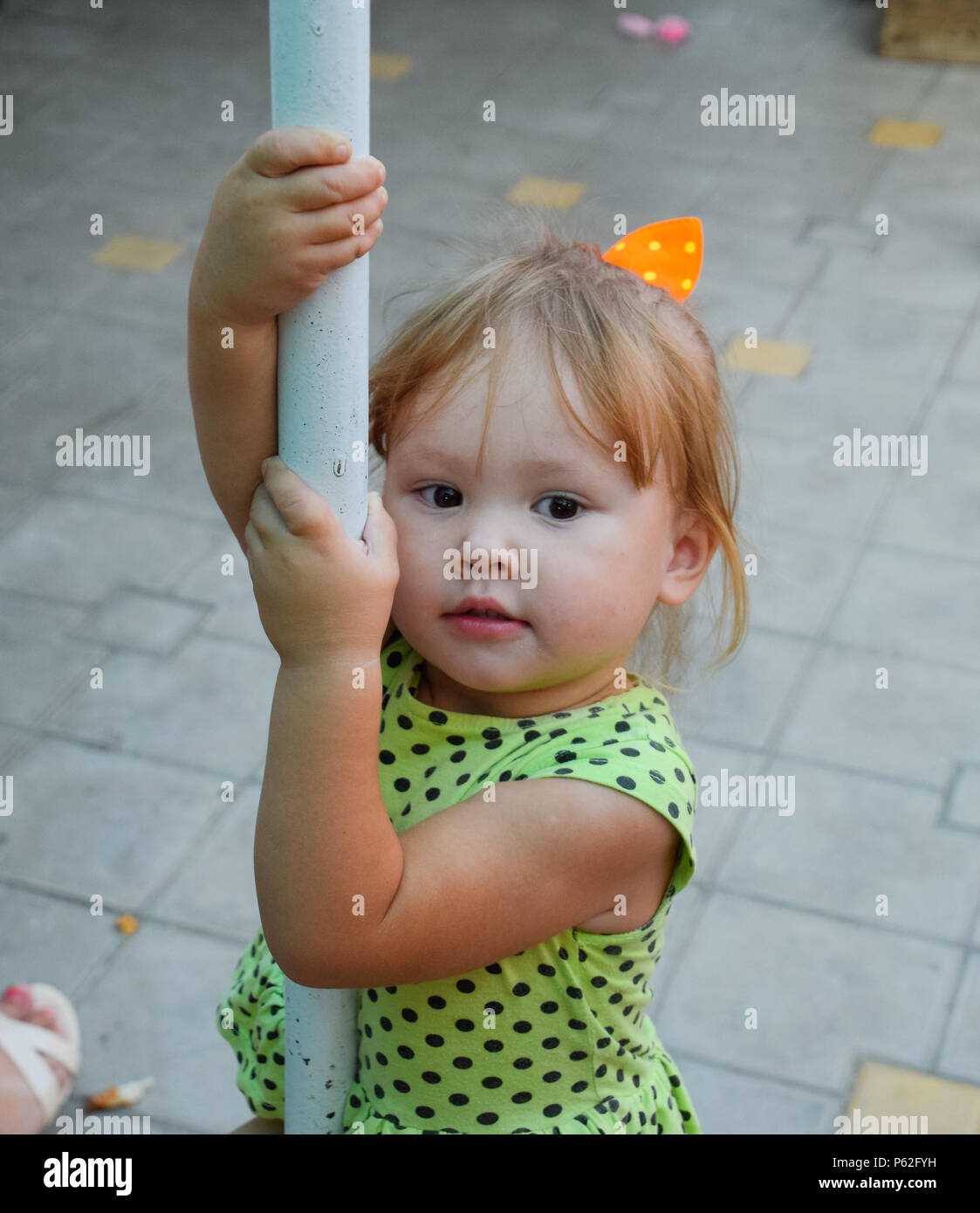 Little girl on the pylon. child Game. Stock Photo