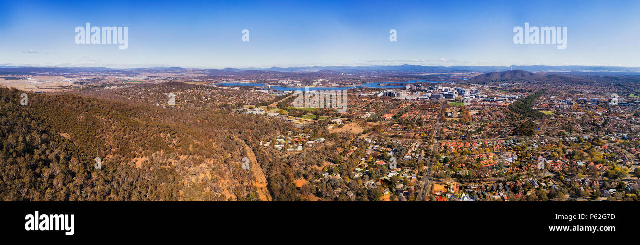 From airport field through Lake Burley Griffin and surrounding suburbs to TV tower and city CBD of Canberra in Australian capital territory Stock Photo