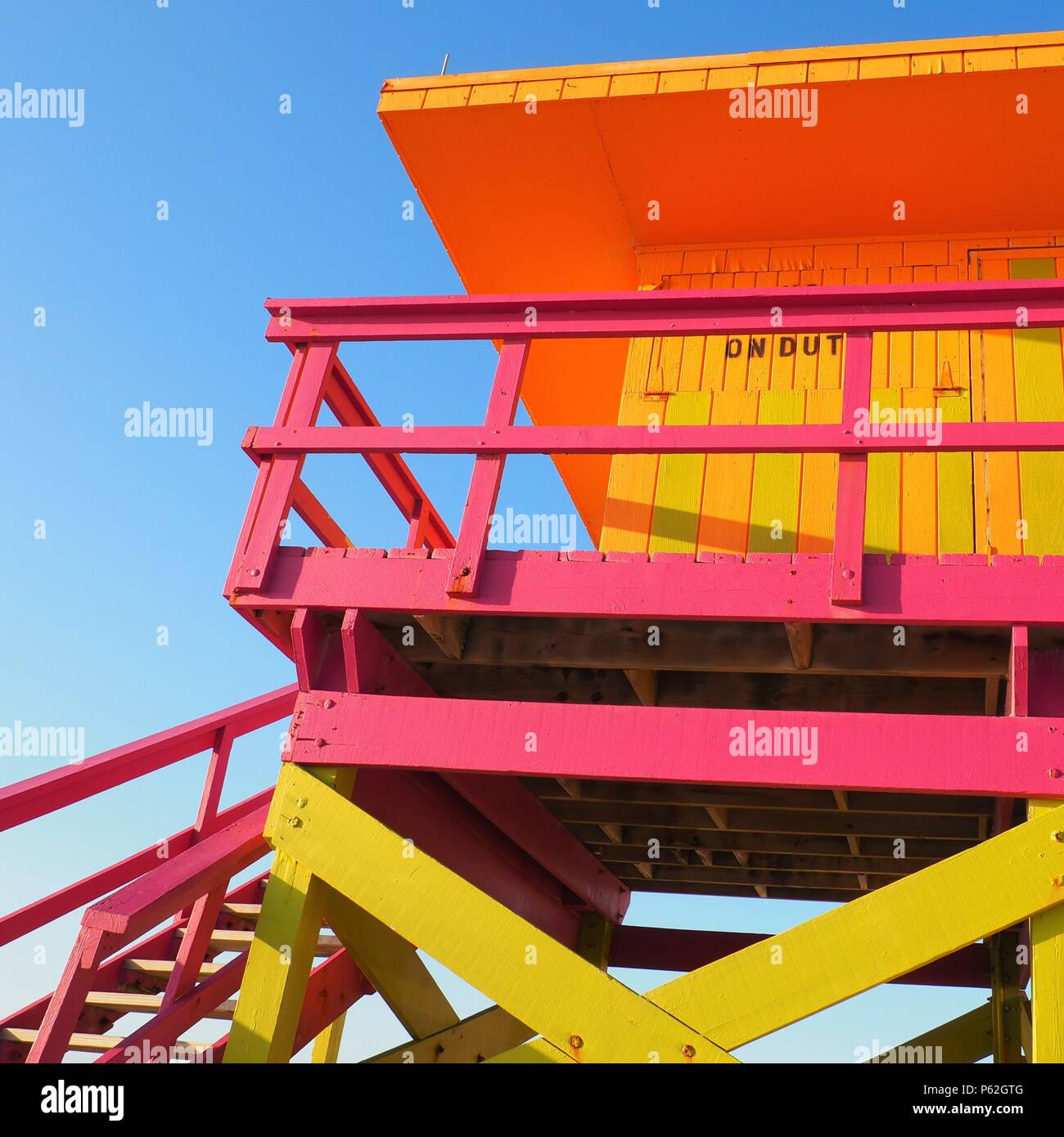 Miami Beach Florida: orange, green/yellow, and pink striped lifeguard tower Stock Photo