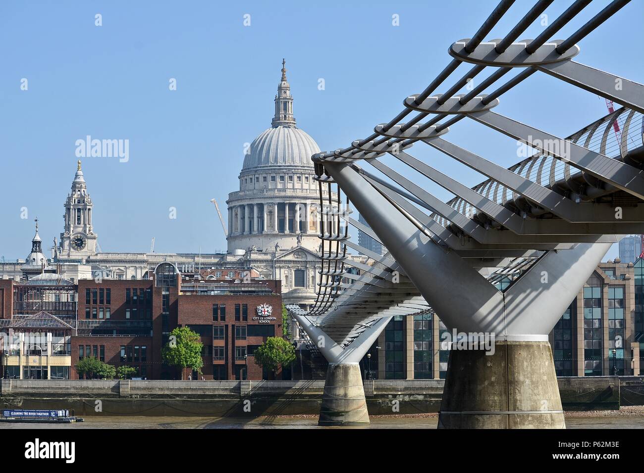 Saint Pauls Cathederal's iconic dome and steeple as seen from the River Thames and Millennium Pedestrian Bridge, London, United Kingdom. Stock Photo