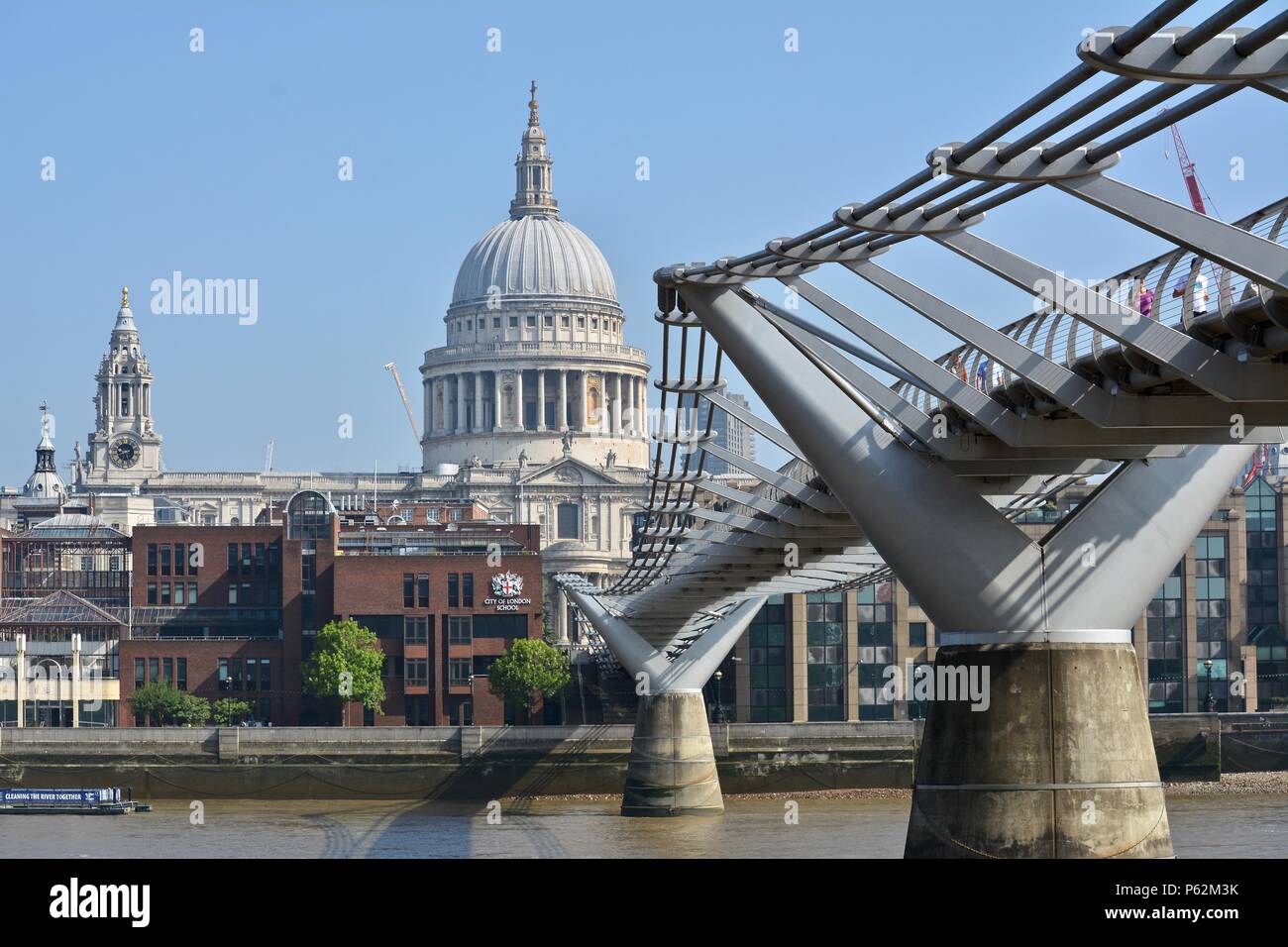 Saint Pauls Cathederal's iconic dome and steeple as seen from the River Thames and Millennium Pedestrian Bridge, London, United Kingdom. Stock Photo