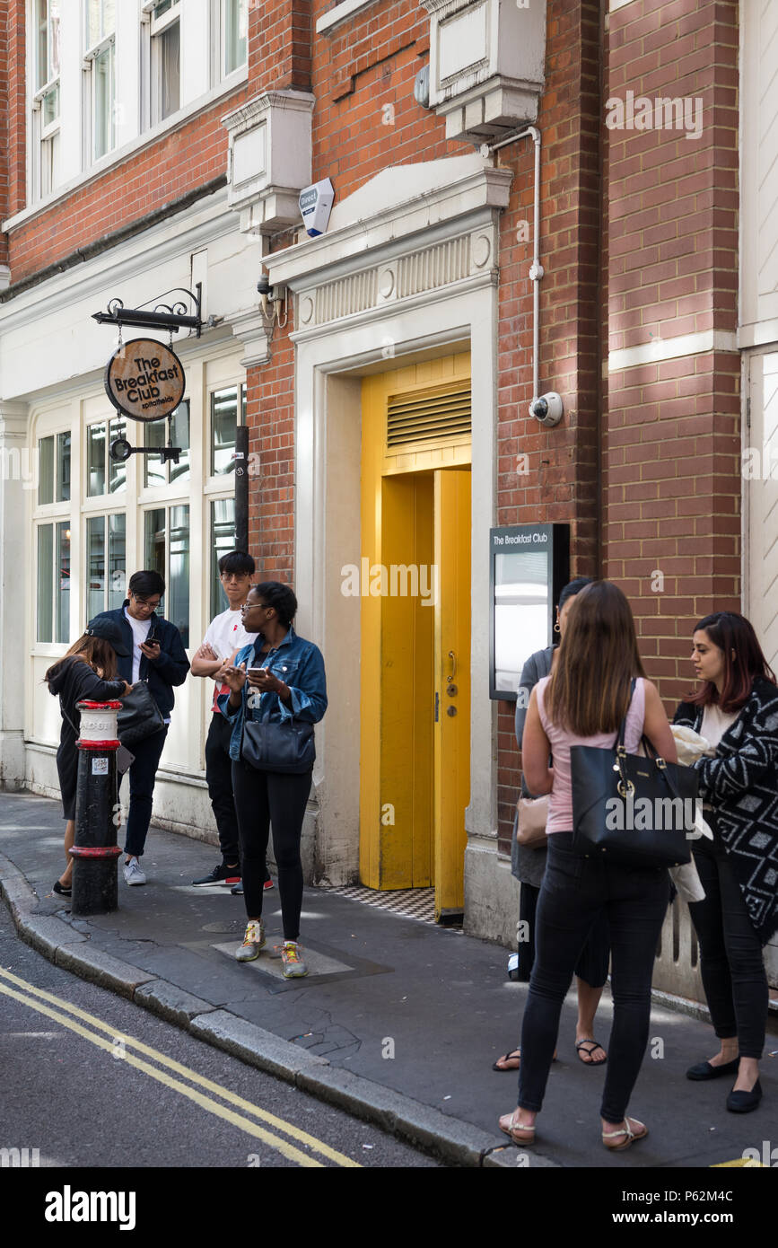 Diners waiting to get into The Breakfast Club restaurant in Artillery Lane, Spitalfields, London, England Stock Photo