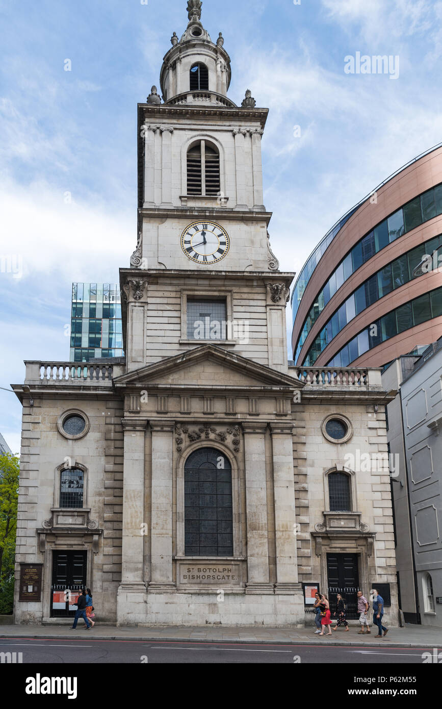 A small group of people walk past the Parish and Ward Church of St. Botolph without Bishopsgate, London England, UK Stock Photo
