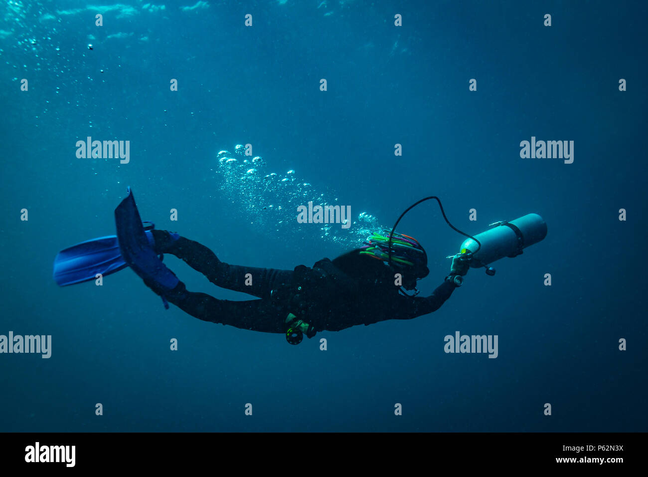 Scubadiver in a sidemount configuration of equipment Stock Photo