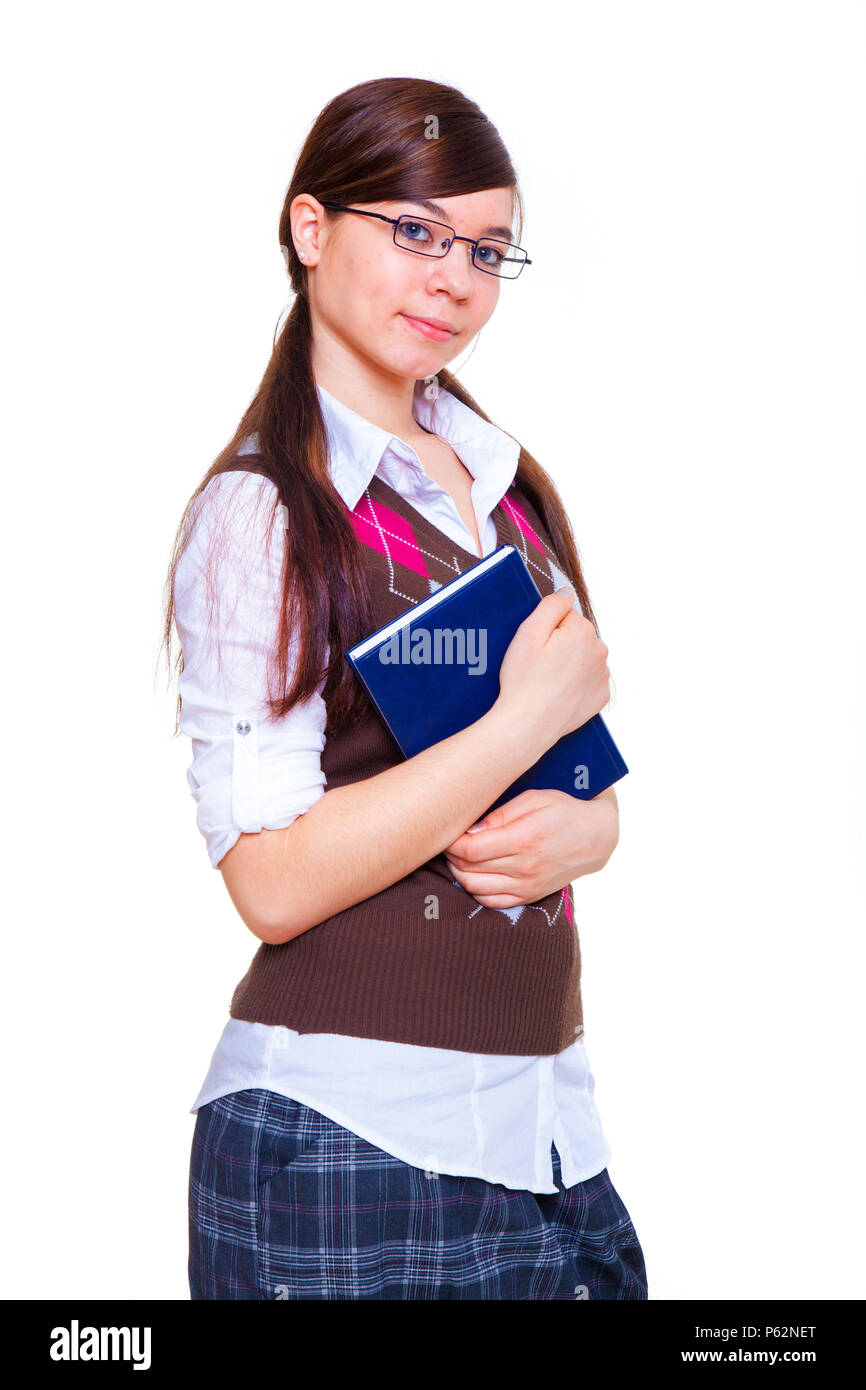 schoolgirl standing with book in hands Stock Photo - Alamy
