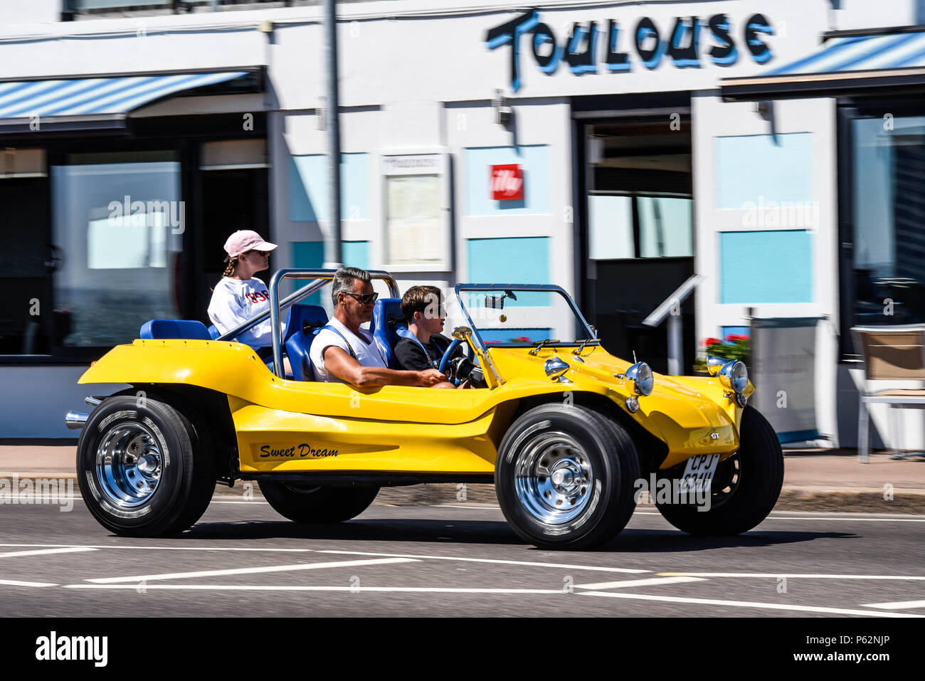 Yellow Dune Buggy, Beach Buggy, named sweet dream driving past Toulouse restaurant on Western Esplanade, Southend on Sea, Essex, UK Stock Photo