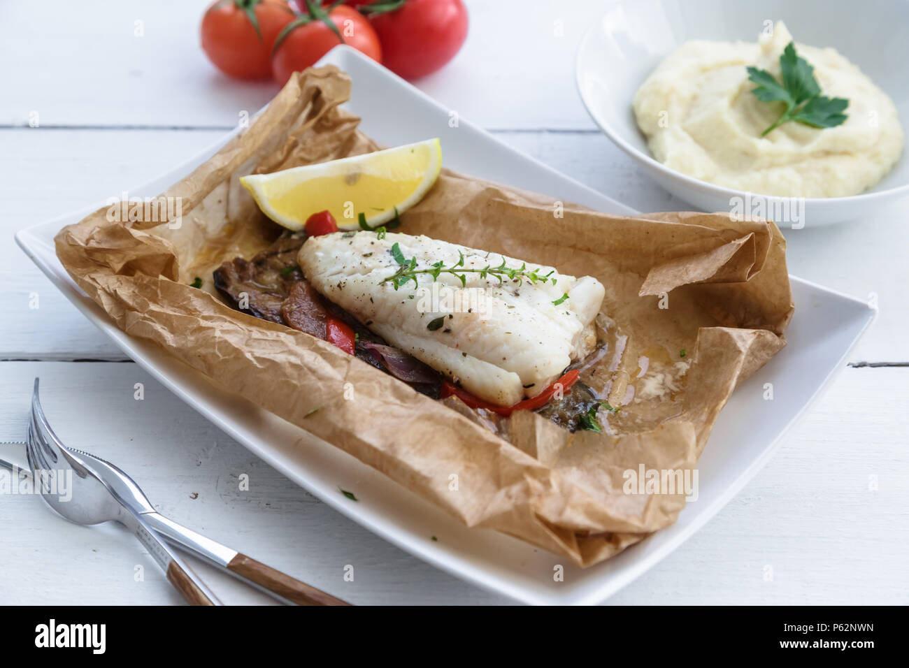 Cod fillets baked in parchment paper with vegetables Stock Photo Alamy
