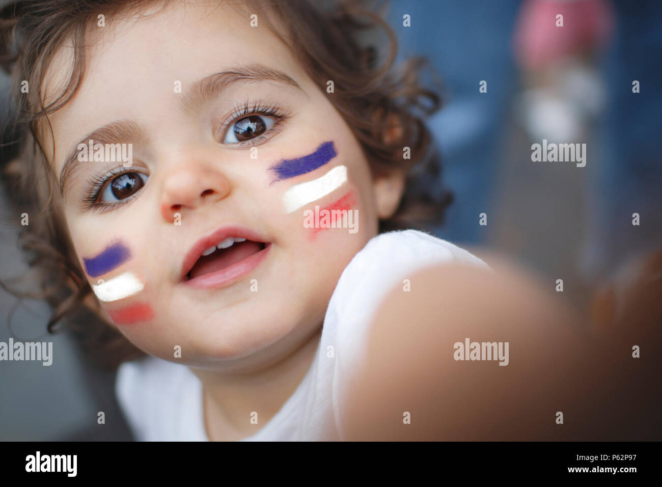 Kid fan with blue white and red flag painted on face Stock Photo