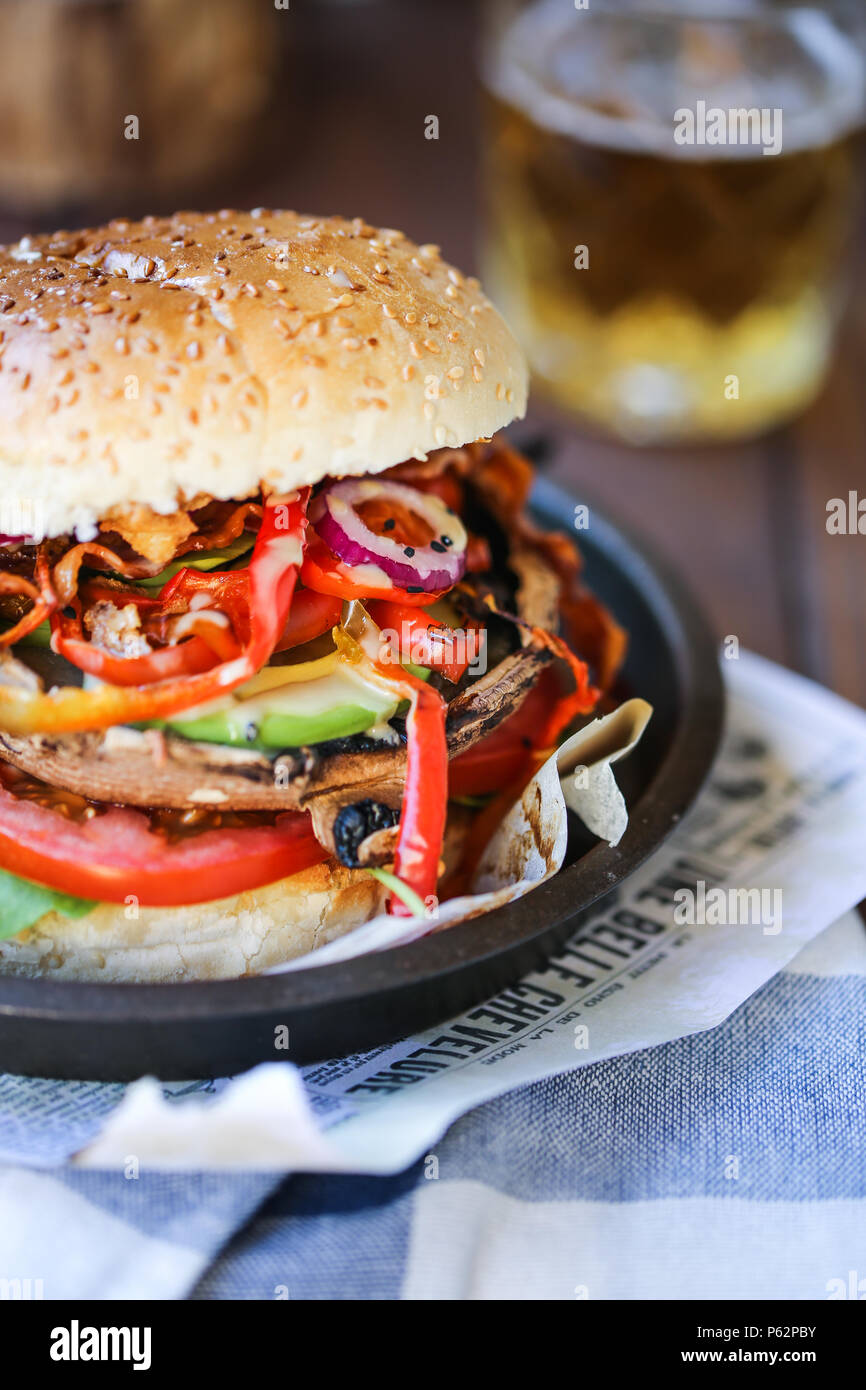 Delicious grilled portobello mushroom burger with a lot of veggies