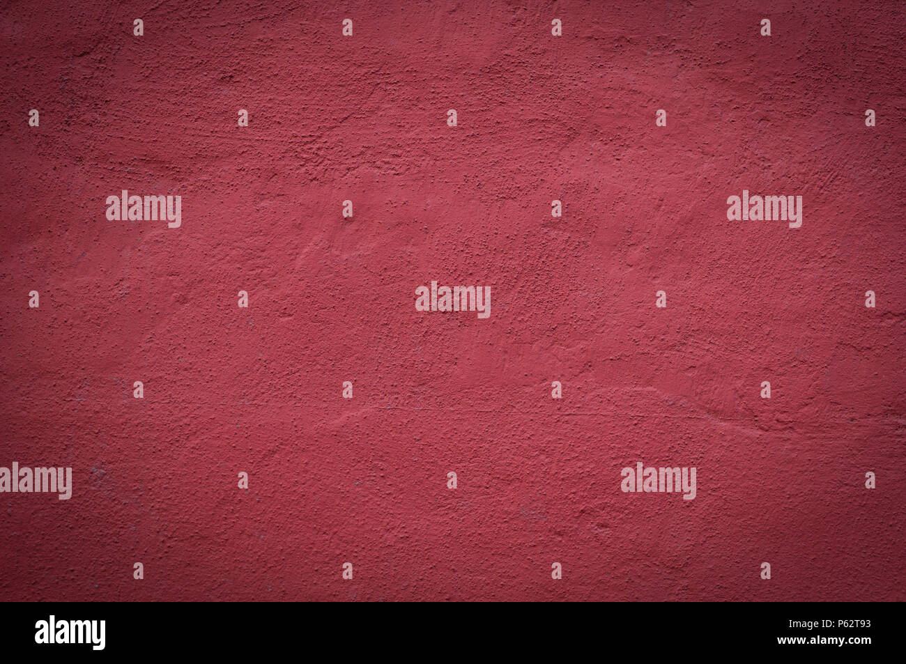cemented wall painted red background. texture, vignette. Stock Photo