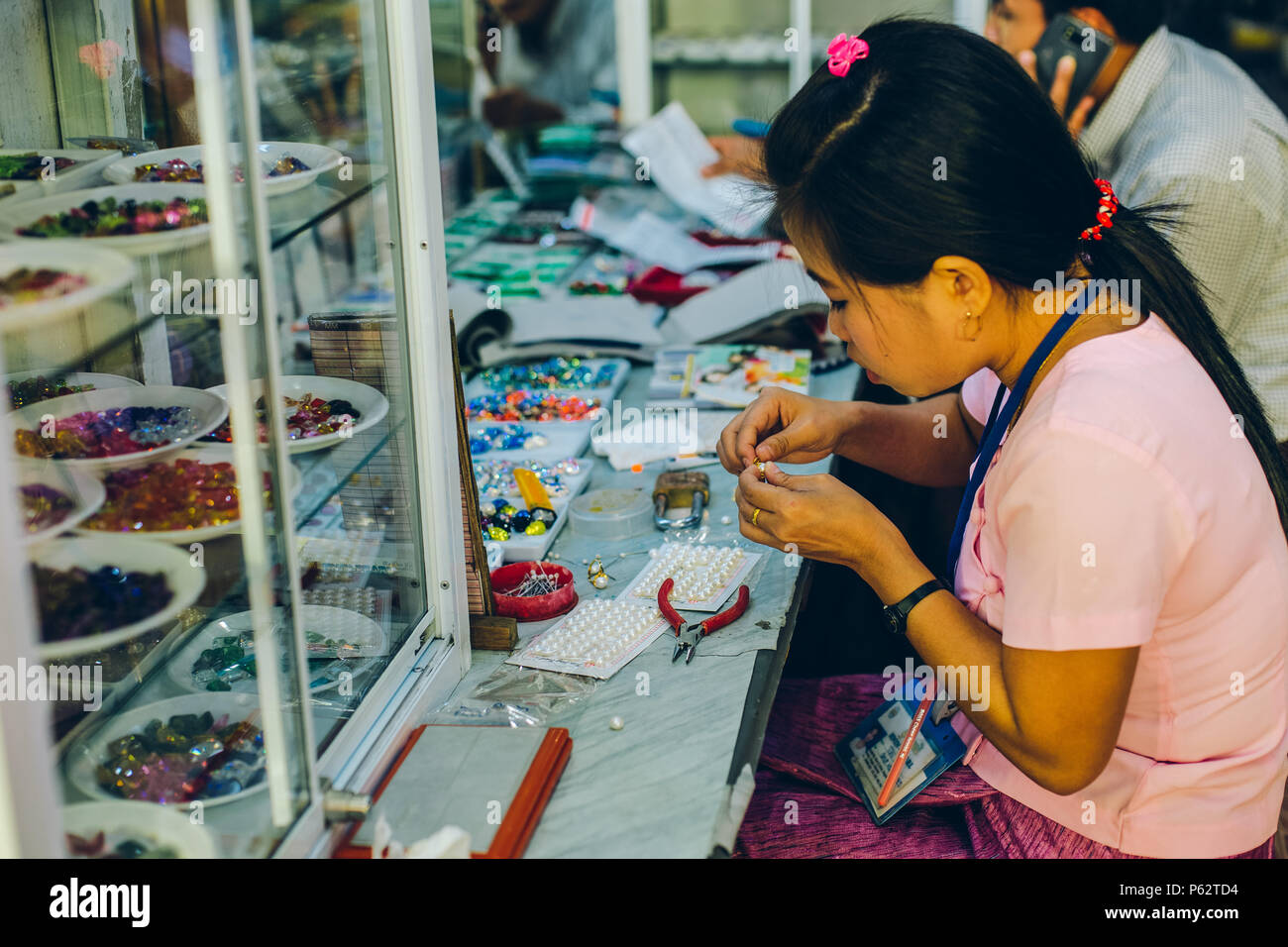 Yangon, Myanmar FEB 19th 2014 Women work in a jewelry shop of