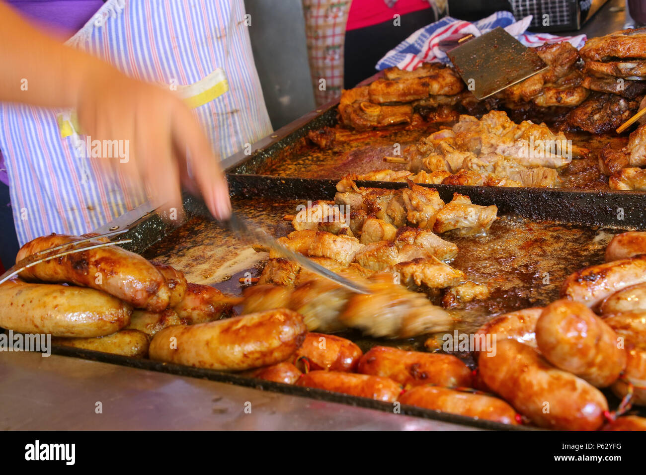 Meat is being cooked for asado at Mercado 4 in Asuncion, Paraguay Stock Photo