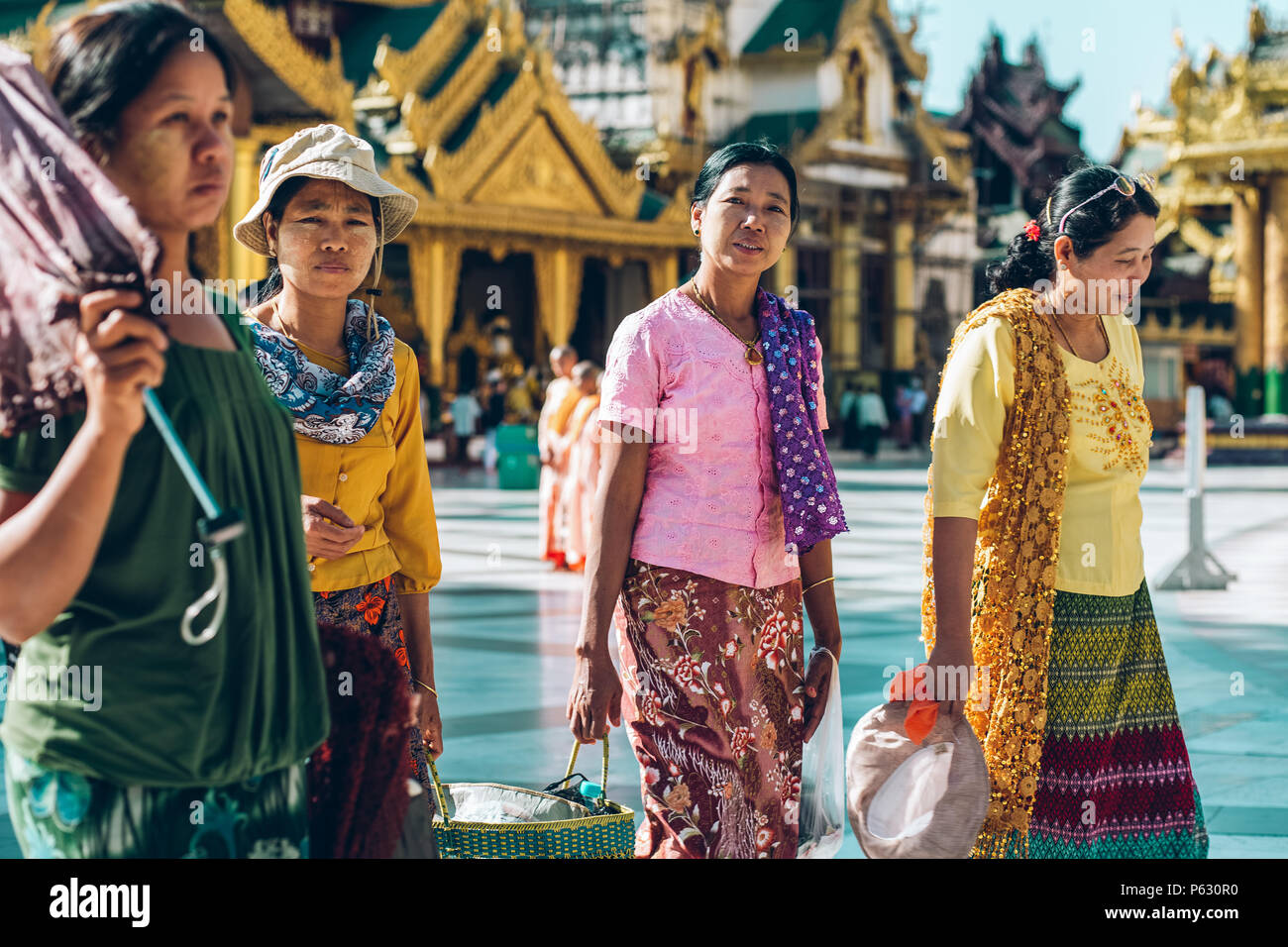 Yangon, Myanmar - FEB 19th 2014: Burmese female walk at Shwedagon Pagoda Stock Photo