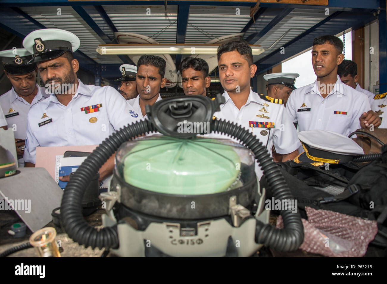 Members of the Sri Lanka navy listen as Explosive Ordnance Disposal