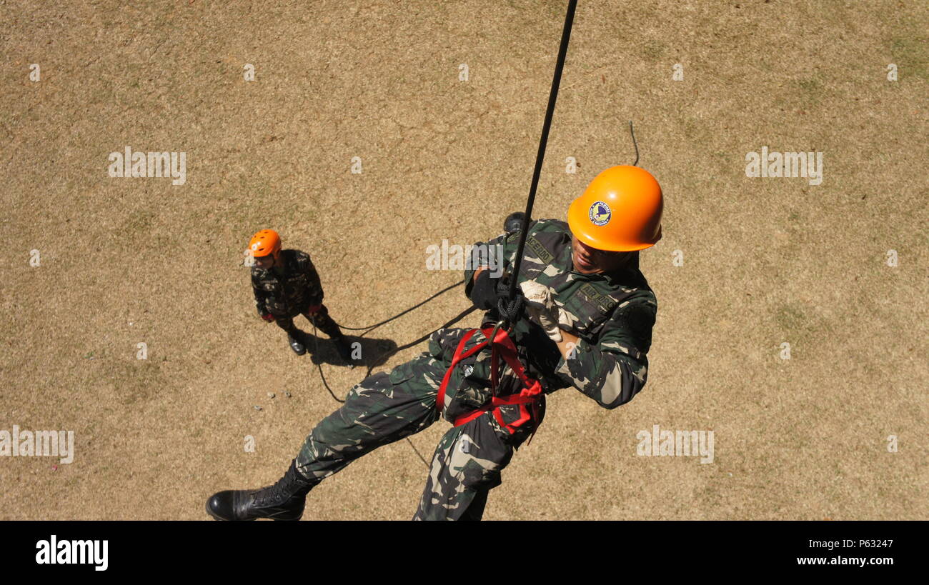 A member of the Armed Forces of the Philippines performs a tower rappel ...