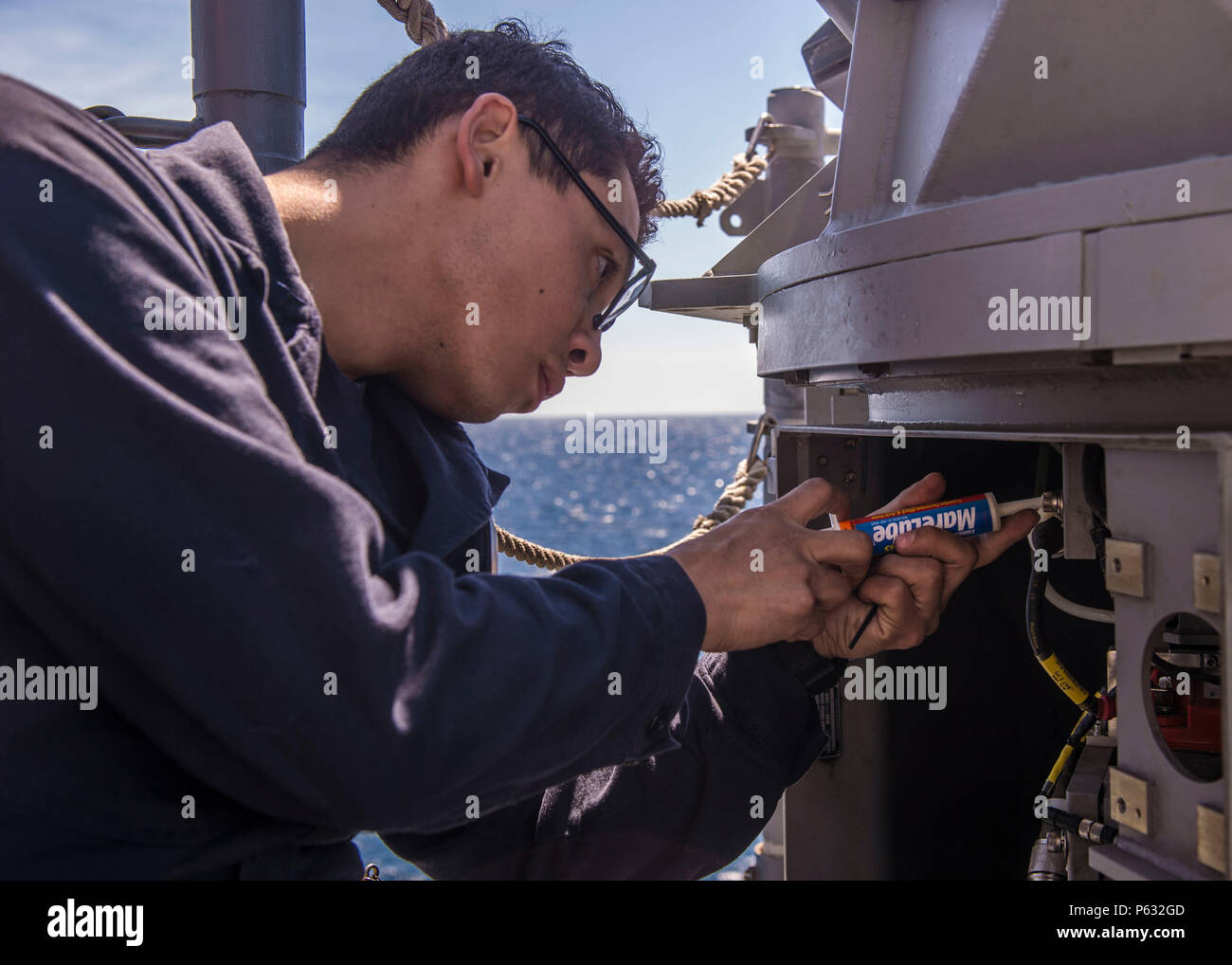 20160403-N-FV739-051  PACIFIC OCEAN (April 3, 2016) – Gunner’s Mate 3rd Class Yeison Bobadilla performs maintenance on a 25mm Mk 38 Mod 2 machine gun system on the fantail of guided-missile cruiser USS Port Royal (CG 73) during an independent deployer certification exercise (IDCERTEX). The IDCERTEX is designed to certify select U.S. ships as independent deployers as tasked by Commander, U.S. 3rd Fleet. (U.S. Navy photo by Mass Communication Specialist 3rd Class Christopher A. Veloicaza/Released) Stock Photo