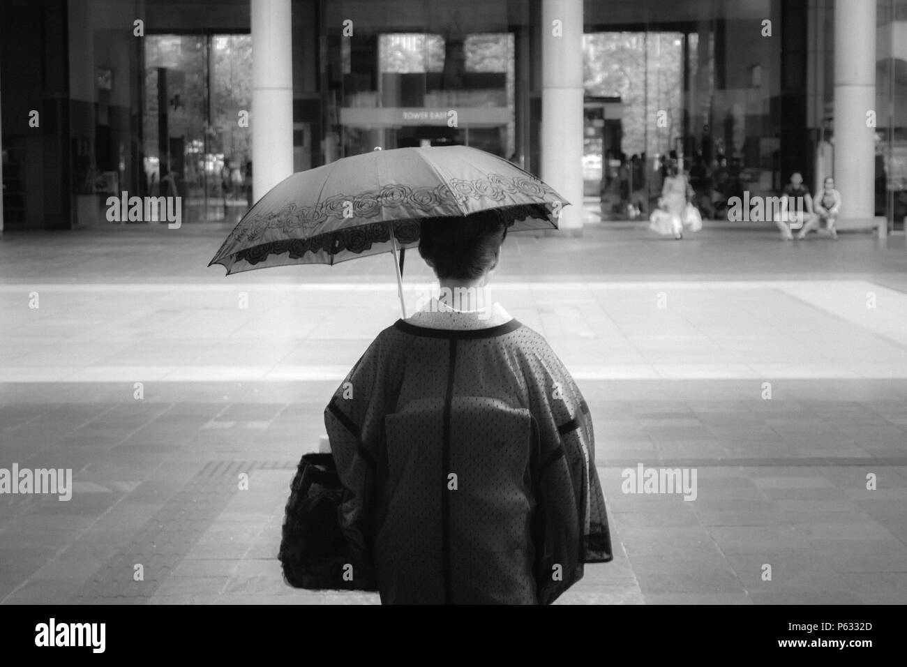 TOKYO, JAPAN - AUGUST, 2017: Japanesse woman walking with an umbrella in Tokyio. Stock Photo