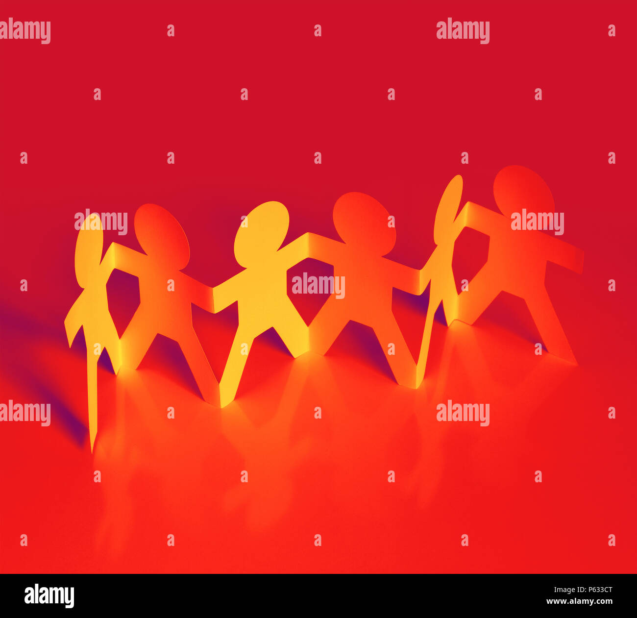 Team of paper chain people in a row holding hands Stock Photo - Alamy