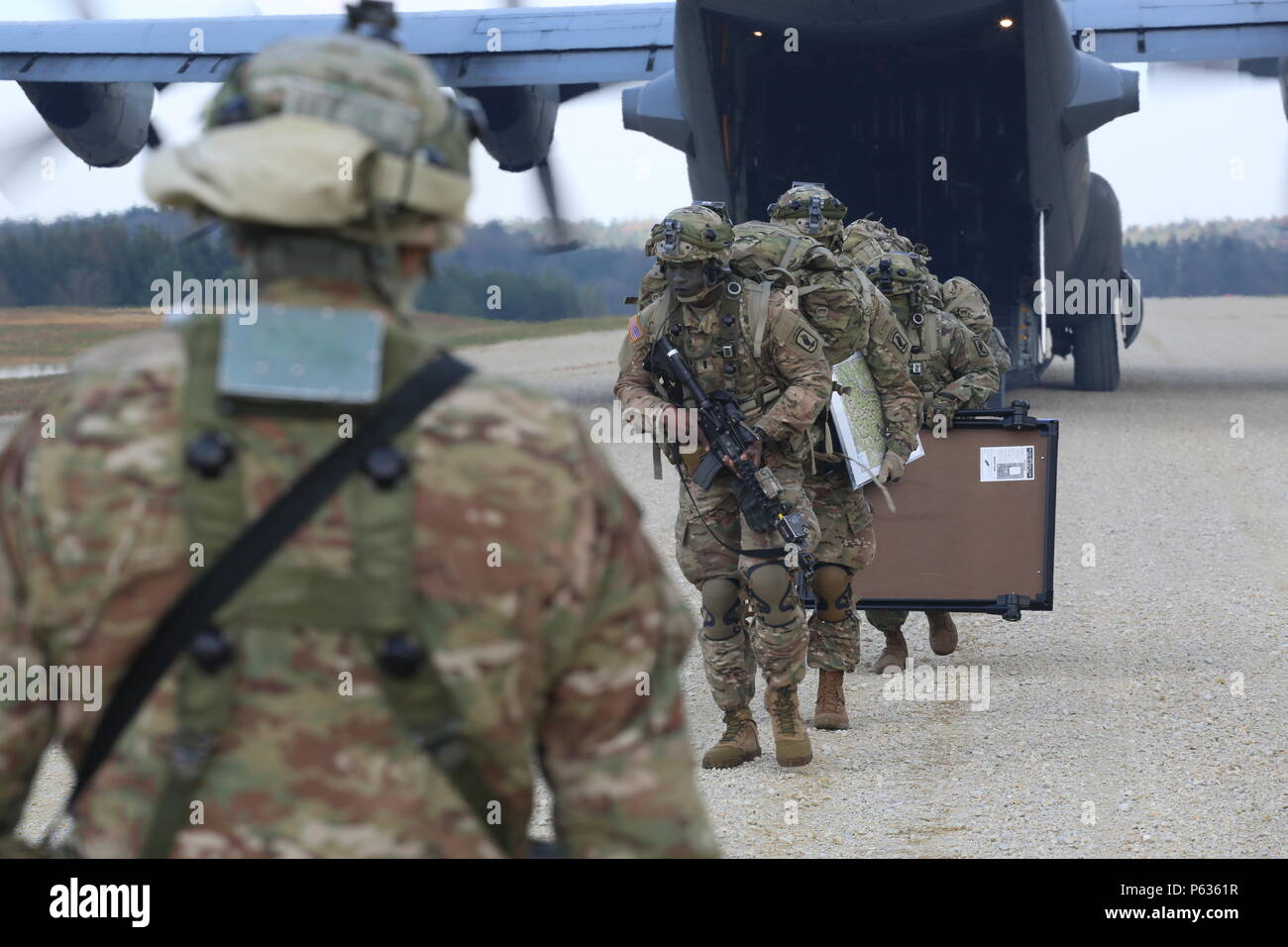 U.S. Soldiers of 54th Brigade Engineer Battalion, 173rd Airborne Brigade maneuver from a Lockheed C-130 Hercules while conducting a cargo unloading operation during exercise Saber Junction 16 at the U.S. Army’s Joint Multinational Readiness Center (JMRC) in Hohenfels, Germany, April 14, 2016. Saber Junction 16 is the U.S. Army Europe’s 173rd Airborne Brigade’s combat training center certification exercise, taking place at the JMRC in Hohenfels, Germany, Mar. 31-Apr. 24, 2016.  The exercise is designed to evaluate the readiness of the Army’s Europe-based combat brigades to conduct unified land  Stock Photo