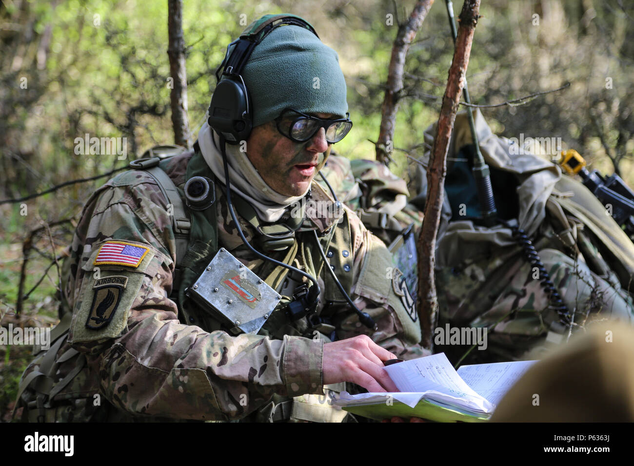 A U.S. Soldier of the 173rd Airborne Brigade discuss mission updates while conducting a pre-mission brief during exercise Saber Junction 16 at the U.S. Army’s Joint Multinational Readiness Center (JMRC) in Hohenfels, Germany, April 13, 2016. Saber Junction 16 is the U.S. Army Europe’s 173rd Airborne Brigade’s combat training center certification exercise, taking place at the JMRC in Hohenfels, Germany, Mar. 31-Apr. 24, 2016.  The exercise is designed to evaluate the readiness of the Army’s Europe-based combat brigades to conduct unified land operations and promote interoperability in a joint,  Stock Photo