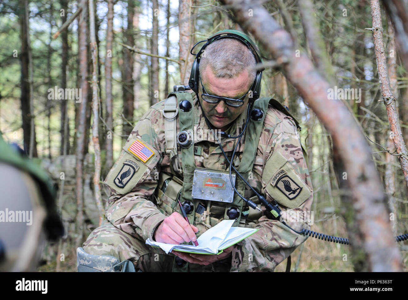 A U.S. Soldier of the 173rd Airborne Brigade writes corrects coordinates while conducting a pre-missions brief during exercise Saber Junction 16 at the U.S. Army’s Joint Multinational Readiness Center (JMRC) in Hohenfels, Germany, April 13, 2016. Saber Junction 16 is the U.S. Army Europe’s 173rd Airborne Brigade’s combat training center certification exercise, taking place at the JMRC in Hohenfels, Germany, Mar. 31-Apr. 24, 2016.  The exercise is designed to evaluate the readiness of the Army’s Europe-based combat brigades to conduct unified land operations and promote interoperability in a jo Stock Photo