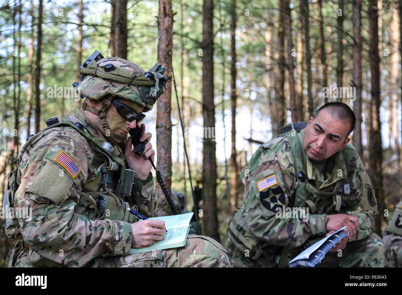 U.S. Soldiers of the 173rd Airborne Brigade discuss mission updates while conducting a pre-missions brief during exercise Saber Junction 16 at the U.S. Army’s Joint Multinational Readiness Center (JMRC) in Hohenfels, Germany, April 13, 2016. Saber Junction 16 is the U.S. Army Europe’s 173rd Airborne Brigade’s combat training center certification exercise, taking place at the JMRC in Hohenfels, Germany, Mar. 31-Apr. 24, 2016.  The exercise is designed to evaluate the readiness of the Army’s Europe-based combat brigades to conduct unified land operations and promote interoperability in a joint,  Stock Photo