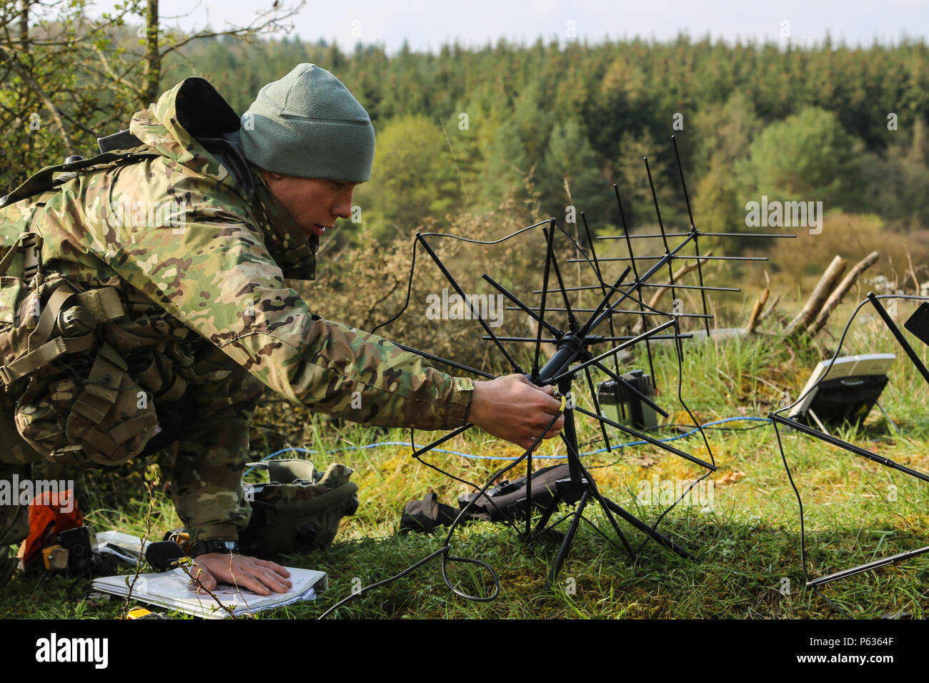A U.S. Soldier of the 173rd Airborne Brigade adjusts a portable antenna while conducting tactical operations during exercise Saber Junction 16 at the U.S. Army’s Joint Multinational Readiness Center (JMRC) in Hohenfels, Germany, April 14, 2016. Saber Junction 16 is the U.S. Army Europe’s 173rd Airborne Brigade’s combat training center certification exercise, taking place at the JMRC in Hohenfels, Germany, Mar. 31-Apr. 24, 2016.  The exercise is designed to evaluate the readiness of the Army’s Europe-based combat brigades to conduct unified land operations and promote interoperability in a join Stock Photo