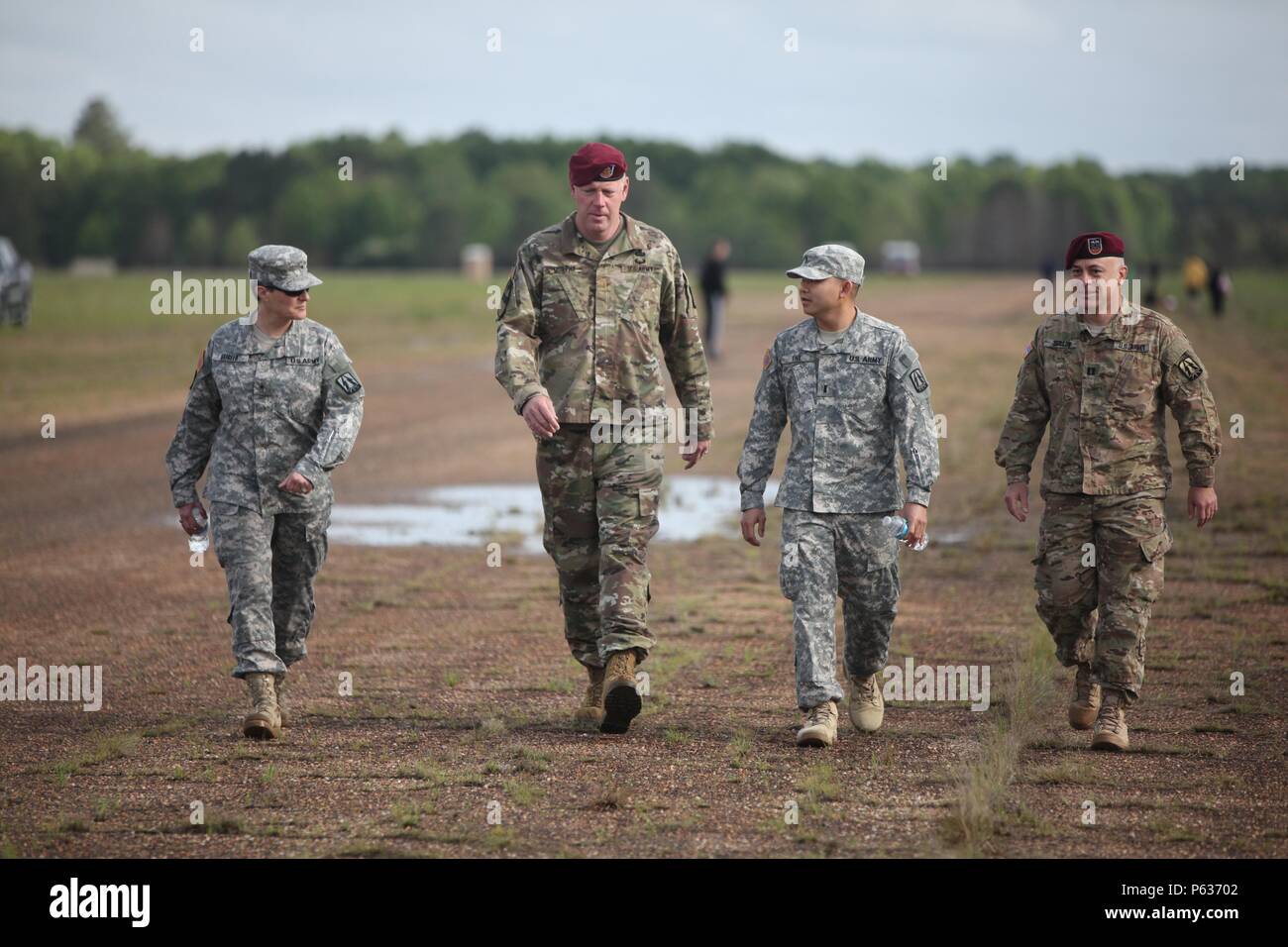 (from left to right) U.S. Army Brig. Gen. Janice Haigler, deputy commander of the 335th Signal Command (Theater), Maj. Christopher Murphy, commander of the 982nd Combat Camera Company (Airborne), 1st Lt. Daniel Lwe assigned to the 335th Theater Signal Command and Capt. Loren Teillon, assigned to the 982nd Combat Camera Combat Company (Airborne), walk to watch another event at the Best Ranger Competition  on Fort Mitchell, Ala., April 16, 2016. The 33rd annual Best Ranger Competition 2016 is a three-day event consisting of challenges to test competitor's physical, mental, and technical capabili Stock Photo
