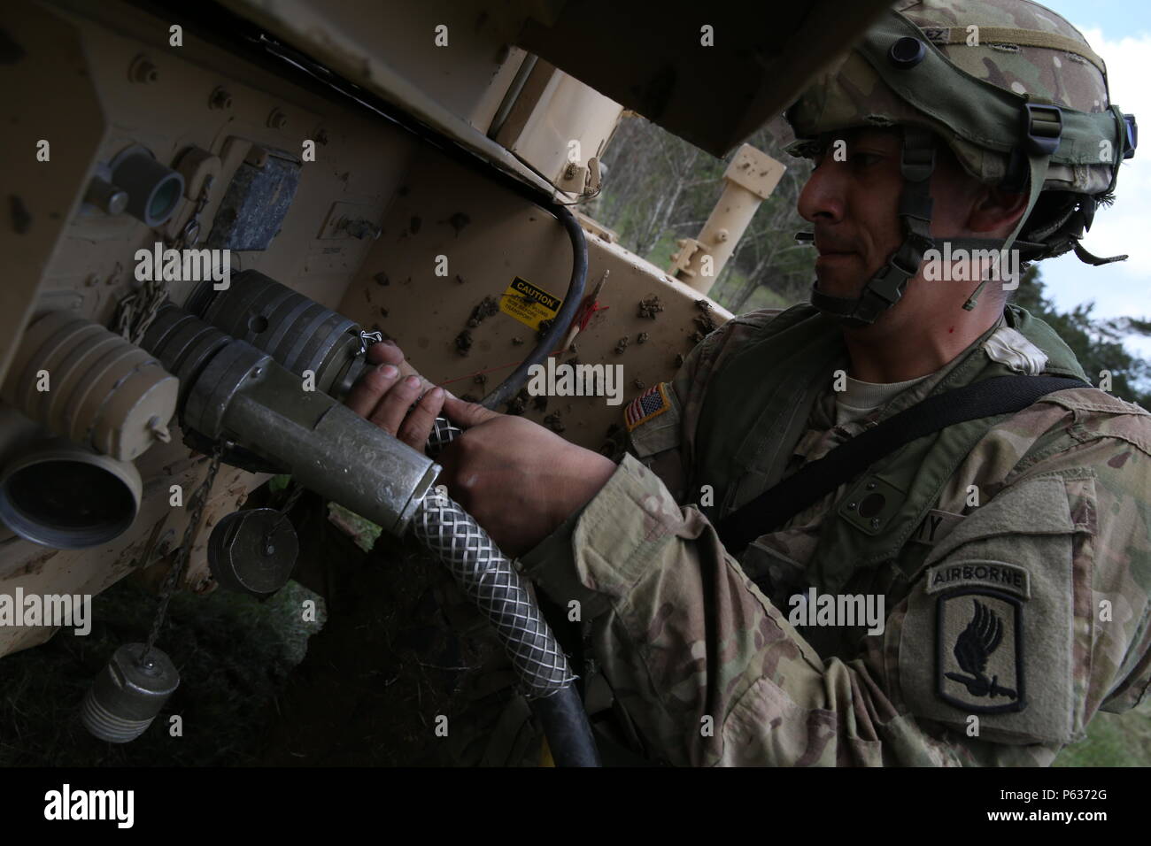 U.S. Army Sgt. David Gonzalez of 4th Battalion, 319th Airborne Field Artillery Regiment, 173rd Airborne Brigade connects power lines to a generator while conducting a site survey during exercise Saber Junction 16 at the U.S. Army’s Joint Multinational Readiness Center (JMRC) in Hohenfels, Germany, April 14, 2016. Saber Junction 16 is the U.S. Army Europe’s 173rd Airborne Brigade’s combat training center certification exercise, taking place at the JMRC in Hohenfels, Germany, Mar. 31-Apr. 24, 2016.  The exercise is designed to evaluate the readiness of the Army’s Europe-based combat brigades to  Stock Photo