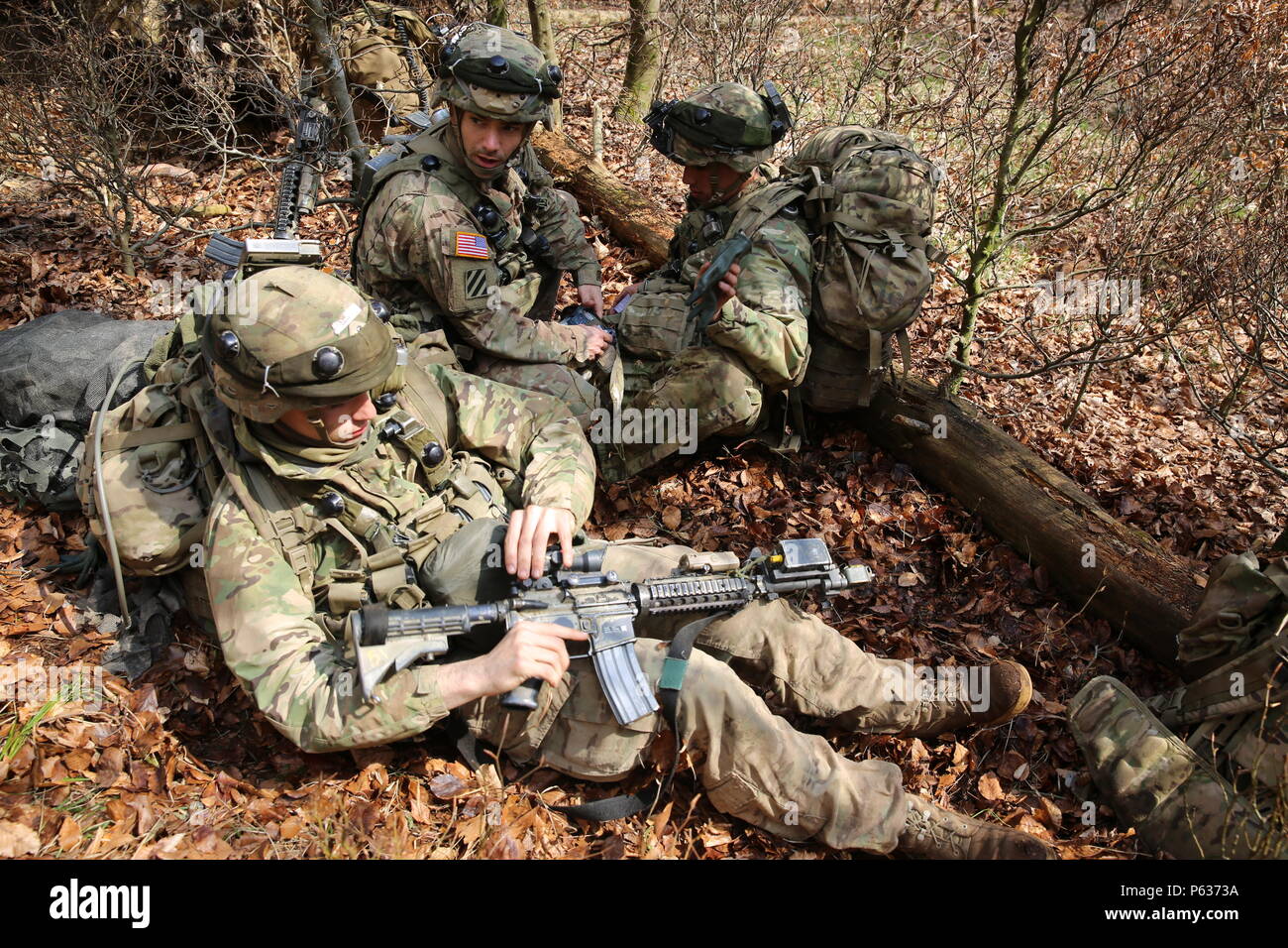 A U.S. Soldier, center, of Comanche Troop, 1st Squadron, 91st Cavalry Regiment, 173rd Airborne Brigade assess simulated casualties while reacting to contact during exercise Saber Junction 16 at the U.S. Army’s Joint Multinational Readiness Center (JMRC) in Hohenfels, Germany, April 14, 2016. Saber Junction 16 is the U.S. Army Europe’s 173rd Airborne Brigade’s combat training center certification exercise, taking place at the JMRC in Hohenfels, Germany, Mar. 31-Apr. 24, 2016.  The exercise is designed to evaluate the readiness of the Army’s Europe-based combat brigades to conduct unified land o Stock Photo