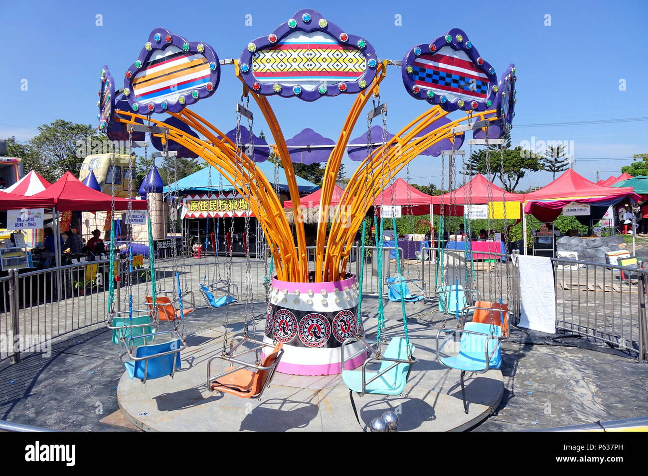 PINGTUNG, TAIWAN -- FEBRUARY 14, 2018: A traditional old style merry-go-round provides entertainment for children at the Pingtung Tropical Agricultura Stock Photo