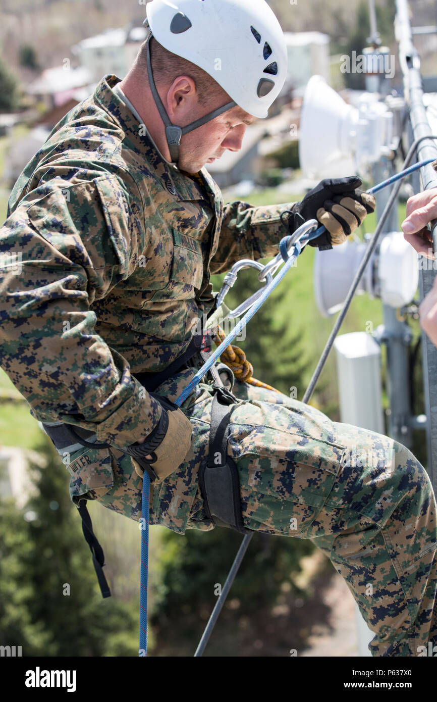 U.S. Marine Corps Staff Sgt. William J. Miller, platoon sergeant with Bravo company, 1st Battalion, 8th Marine Regiment, Special Purpose Marine Air-Ground Task Force-Crisis Response-Africa begins to descend from a ten-story building during a zip lining and rappelling training event in Osseja, France, Apr. 6, 2016. French Commando training instructors hosted realistic commando training with SPMAGTF-CR-AF Marines in order to improve individual movement skills in urban and austere environments. (U.S. Marine Corps photo by Sgt. Kassie L. McDole/Released) Stock Photo
