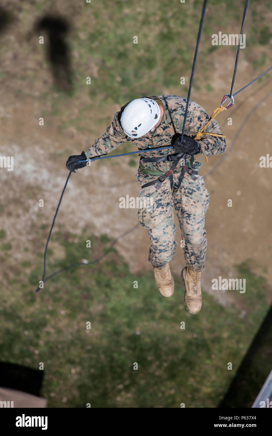 U.S. Marine Corps Cpl. Kyle T. Maurer, squad leader with Bravo company, 1st Battalion, 8th Marine Regiment, Special Purpose Marine Air-Ground Task Force-Crisis Response-Africa begins to descend from a ten-story building during a zip lining and rappelling training event in Osseja, France, Apr. 6, 2016. French Commando training instructors hosted realistic commando training with SPMAGTF-CR-AF Marines in order to improve individual movement skills in urban and austere environments. (U.S. Marine Corps photo by Sgt. Kassie L. McDole/Released) Stock Photo
