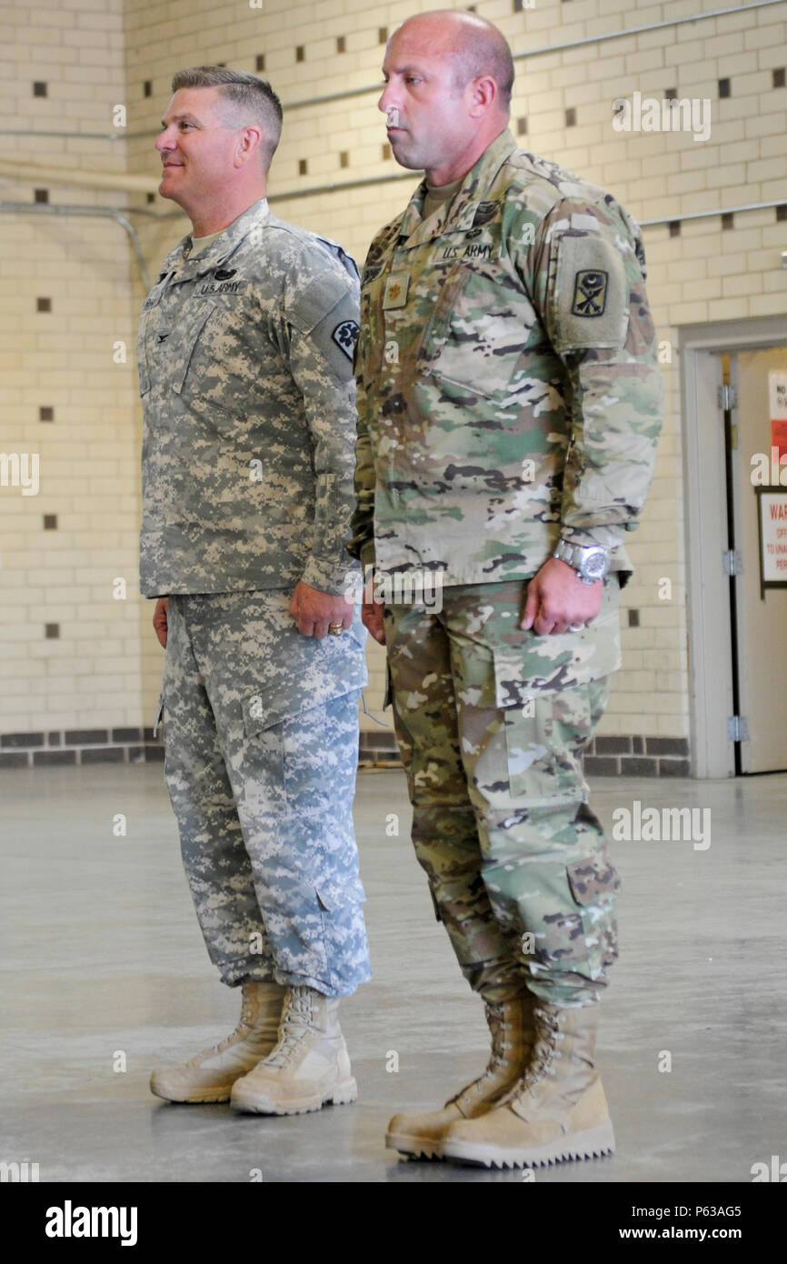 U.S. Army Col. Frank Rice, commander of the 678th Air Defense Brigade, South Carolina National Guard, and U.S. Army Maj. Brett Snyder, from the 263rd Army Air and Missile Defense Command, stand at attention during Snyder’s promotion ceremony held at the 678th Air Defense Brigade in Eastover, S.C., April 16, 2016. Snyder was promoted to Lt. Col. (U.S. Army National Guard photo by Staff Sgt. Kevin Pickering/Released) Stock Photo
