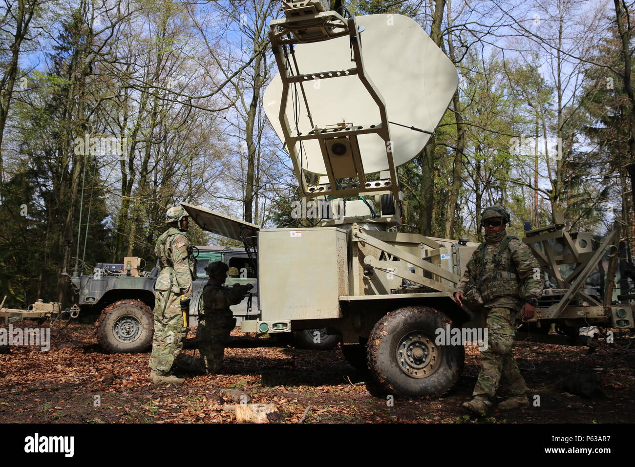 U.S. Soldiers of 1st Squadron, 91st Cavalry Regiment, 173rd Airborne Brigade perform pre-combat checks on a Satellite Transportable Terminal while conducting tactical operations during exercise Saber Junction 16 at the U.S. Army’s Joint Multinational Readiness Center (JMRC) in Hohenfels, Germany, April 16, 2016. Saber Junction 16 is the U.S. Army Europe’s 173rd Airborne Brigade’s combat training center certification exercise, taking place at the JMRC in Hohenfels, Germany, Mar. 31-Apr. 24, 2016.  The exercise is designed to evaluate the readiness of the Army’s Europe-based combat brigades to c Stock Photo