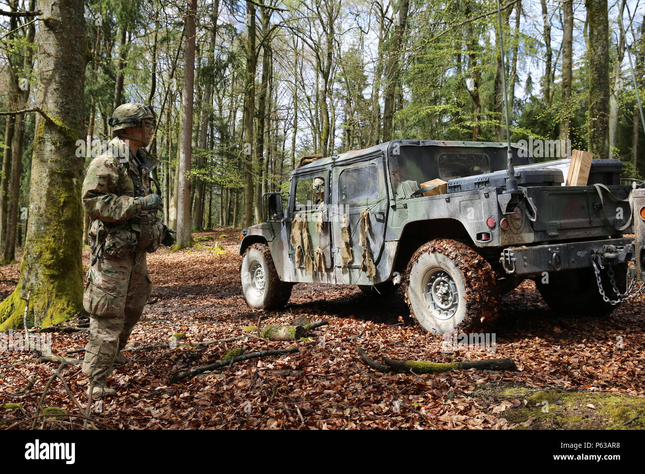 U.S. Soldier, left, of 1st Squadron, 91st Cavalry Regiment, 173rd Airborne Brigade ground guides a Humvee while conducting tactical operations during exercise Saber Junction 16 at the U.S. Army’s Joint Multinational Readiness Center (JMRC) in Hohenfels, Germany, April 16, 2016. Saber Junction 16 is the U.S. Army Europe’s 173rd Airborne Brigade’s combat training center certification exercise, taking place at the JMRC in Hohenfels, Germany, Mar. 31-Apr. 24, 2016.  The exercise is designed to evaluate the readiness of the Army’s Europe-based combat brigades to conduct unified land operations and  Stock Photo
