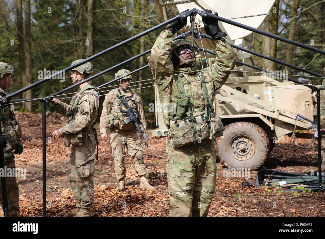 U.S. Soldiers of 1st Squadron, 91st Cavalry Regiment, 173rd Airborne Brigade construct a tent while conducting tactical operations during exercise Saber Junction 16 at the U.S. Army’s Joint Multinational Readiness Center (JMRC) in Hohenfels, Germany, April 16, 2016. Saber Junction 16 is the U.S. Army Europe’s 173rd Airborne Brigade’s combat training center certification exercise, taking place at the JMRC in Hohenfels, Germany, Mar. 31-Apr. 24, 2016.  The exercise is designed to evaluate the readiness of the Army’s Europe-based combat brigades to conduct unified land operations and promote inte Stock Photo