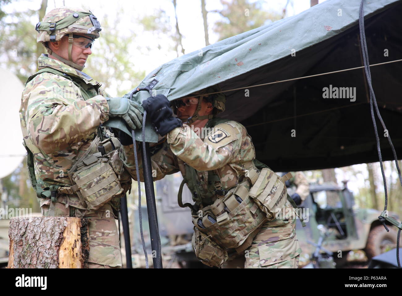 U.S. Soldiers of 1st Squadron, 91st Cavalry Regiment, 173rd Airborne Brigade construct a tent while conducting tactical operations during exercise Saber Junction 16 at the U.S. Army’s Joint Multinational Readiness Center (JMRC) in Hohenfels, Germany, April 16, 2016. Saber Junction 16 is the U.S. Army Europe’s 173rd Airborne Brigade’s combat training center certification exercise, taking place at the JMRC in Hohenfels, Germany, Mar. 31-Apr. 24, 2016.  The exercise is designed to evaluate the readiness of the Army’s Europe-based combat brigades to conduct unified land operations and promote inte Stock Photo